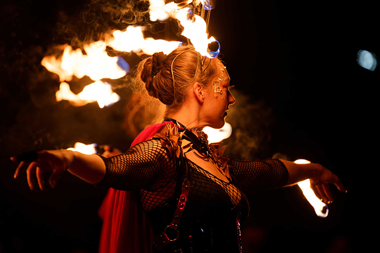 Performer Felicity Boyd of Motus Collective. Performing with Fire Crown and Fire Fingers. Fire performance at UNSEEN Winter Solstice Fire Festival 2023, event by Dragon Mill, Light Square, Adelaide, photo by Bill J Pearce