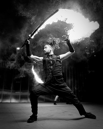 Performer Timmehtek of Dragon Mill, Performing with lycopodium Sword. Group Choreography for 'the Ritual' at UNSEEN Winter Solstice Fire Festival 2023, event by Dragon Mill, Light Square, Adelaide, photo by Bill J Pearce