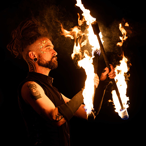 Performer Timmehtek of Dragon Mill, Performing with double staff. Fire performance at UNSEEN Winter Solstice Fire Festival 2023, event by Dragon Mill, Light Square, Adelaide, photo by Bill J Pearce