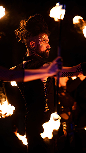Performer Timmehtek of Dragon Mill, Performing with double staff. Fire entertainment at UNSEEN Winter Solstice Fire Festival 2023, event by Dragon Mill, Light Square, Adelaide, photo by Bill J Pearce