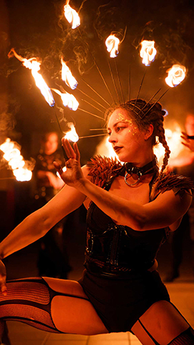 Performer Felicity Boyd of Motus Collective. Performing with Fire Crown and Fire Fingers. Fire performance at UNSEEN Winter Solstice Fire Festival 2023, event by Dragon Mill, Light Square, Adelaide, photo by Bill J Pearce